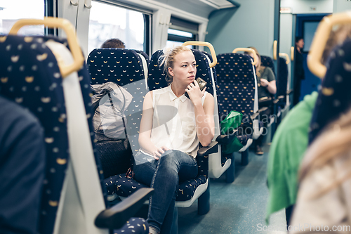 Image of Woman travelling by train.