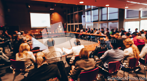 Image of Public speaker giving talk at business event.