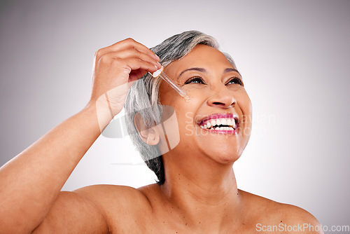 Image of Studio face, mature happy woman or serum hydration, self care and application of facial oil, hyaluronic acid or wellness. Pipette, skincare shine and person thinking of anti aging on white background