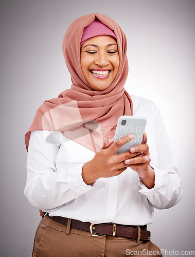 Image of Muslim, phone and woman with smile in studio for social media scroll, internet post or mobile app on gray background. Smartphone, islam and person with happiness for technology, digital web or joy