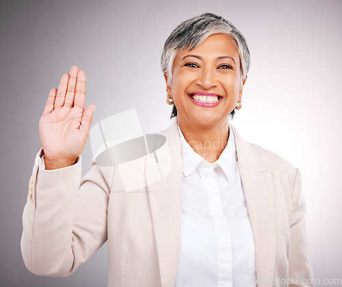 Image of Portrait, senior woman and hand for loyalty, justice or a wave on a studio background. Happy, pledge and a mature employee or manager with a gesture for hello, pride or patriotic with respect