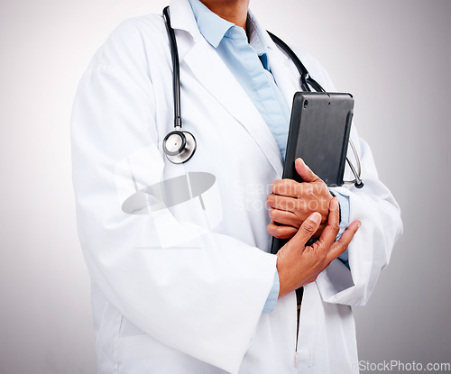 Image of Doctor, technology and hands with tablet in studio for healthcare services, telehealth support and help. Closeup of professional medical worker, digital connection and consulting on grey background