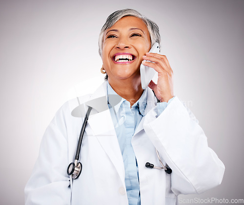 Image of Doctor, phone call and woman in studio for communication, consulting or telehealth contact on grey background. Happy mature medical surgeon laugh for mobile consultation, support or healthcare advice