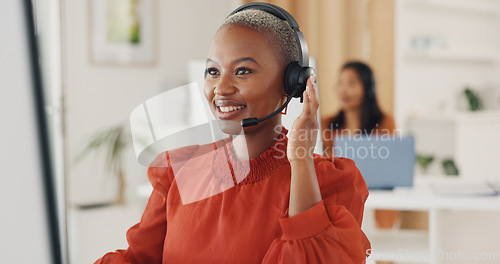 Image of Call center, black woman and communication at computer in office for CRM questions, FAQ contact and IT support. Happy telemarketing agent at desktop for sales advisory, telecom solution or consulting