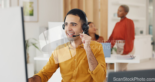 Image of Call center, man and communication at computer in office for CRM questions, FAQ contact and IT support. Happy telemarketing agent at desktop for sales advisory, telecom solution and consulting client