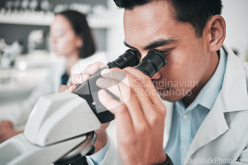Image of Microscope, face of man and laboratory for science research, dna analysis or studying chemical development. Scientist, biotechnology and check lens to review investigation, test or medical assessment