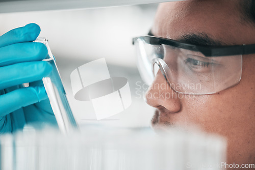 Image of Science, research and man looking at test tube in laboratory, solution for vaccine or medical innovation. Healthcare, biotech lab analytics and medicine, scientist with pharmaceutical sample in glass