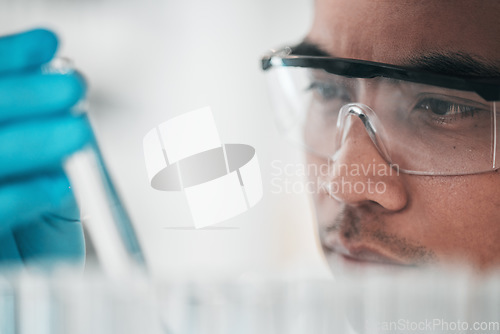 Image of Science, research and man with glasses, test tube and biotech in laboratory, solution for vaccine or medical innovation. Healthcare, lab analytics and medicine, scientist in eco pharmaceutical study.