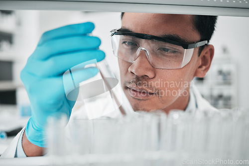 Image of Lab scientist, test tube and face of man in laboratory studying chemical analysis, pharma research and vaccine development. Science, asian chemistry technician and assessment of sample for innovation