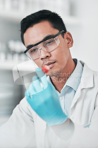 Image of Science, test and man with tube in laboratory for chemical analysis, inspection and vaccine development. Asian scientist with blood sample for dna results, research investigation or pharma assessment