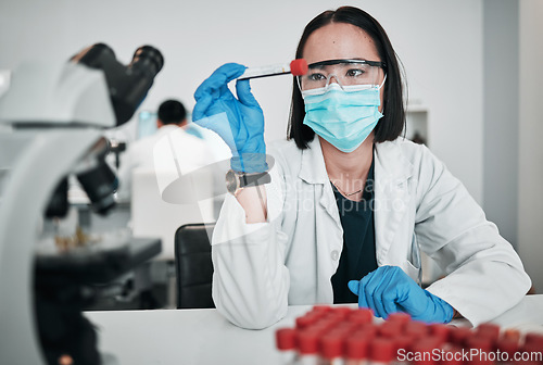 Image of Scientist, blood test and woman in laboratory with face mask for studying medical analysis, inspection and vaccine development. Asian science technician with tube, dna assessment and investigation