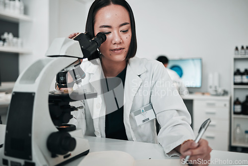 Image of Microscope, woman and writing in laboratory for science research, dna analysis and notes. Asian scientist, biotechnology and review investigation, test report and check lens for assessment results