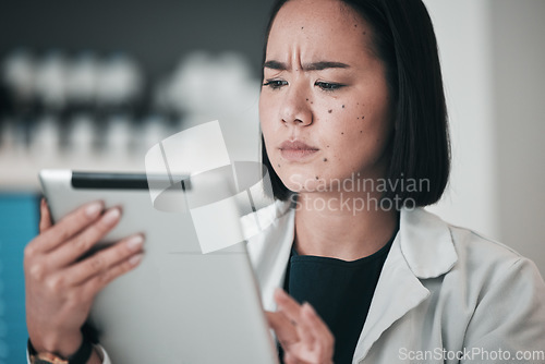 Image of Tablet, pharmacy and confused Asian woman in laboratory for website, wellness app and telehealth. Healthcare, pharmaceutical and worker on digital tech for medical service, medicine and research