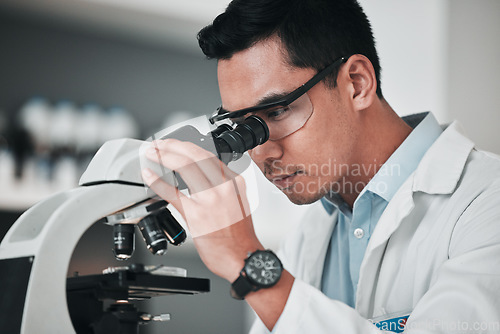 Image of Man, scientist and microscope in forensic science, research or new discovery at laboratory. Male person, medical or healthcare specialist looking in scope for DNA, vaccine or cure to virus in lab