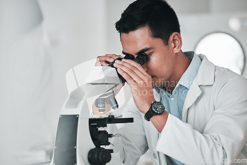 Image of Man, scientist and microscope in forensic, research or new science discovery at laboratory. Male person, medical or healthcare specialist looking in scope for DNA, vaccine or cure to virus in lab