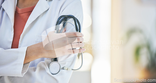 Image of Woman, doctor and hands with stethoscope of professional in healthcare, cardiology or advice at hospital. Closeup of female person or medical expert with arms crossed, equipment or examination tool