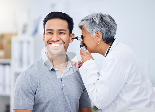 Image of Doctor, patient or ear check for healthcare or wellness at hospital with otolaryngology specialist. Man, smile or senior physician woman with otoscope test for hearing problem or medical consultation
