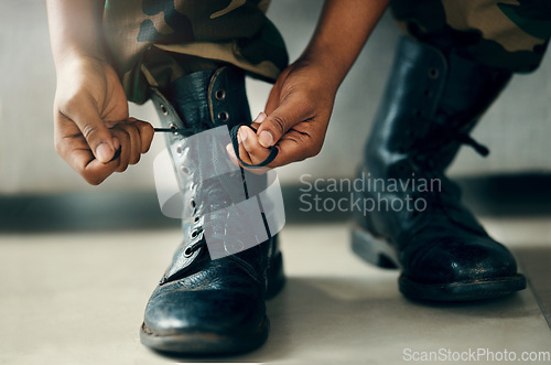 Image of Hands tie shoes, closeup and soldier in army getting ready to start war, battle or fight. Boots, man tying laces in military and veteran preparing gear for training, exercise and workout to travel