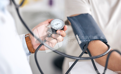 Image of Hands, blood pressure and doctor with patient in consultation at hospital in clinic test. Hypertension, exam and arm of person with medical professional for check up for heart health, advice and care