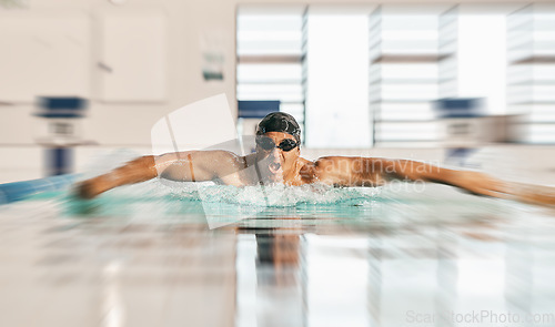 Image of Swimming action, pool and sports man doing water challenge, cardio training or butterfly stroke action. Motivation, speed blur and swimmer workout, practice or training for competition, match or race