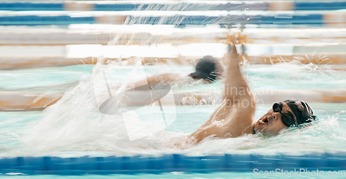 Image of Fitness, water and a swimmer in a pool during a race, competition or cardio training at a gym. Exercise, sports and workout with an athlete swimming to improve speed, health or freestyle performance