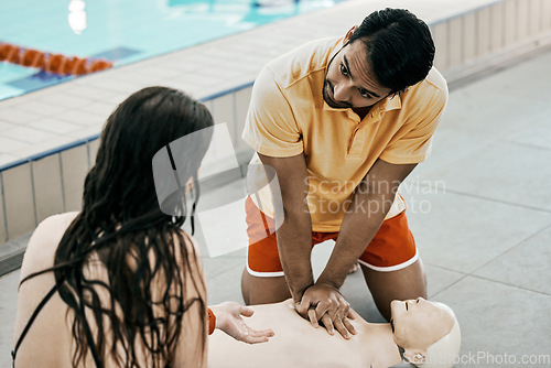 Image of Swimming pool safety, first aid and man teaching life saving process rescue support or helping with danger. Client, emergency CPR and person learning medical service, lifeguard or practice on dummy