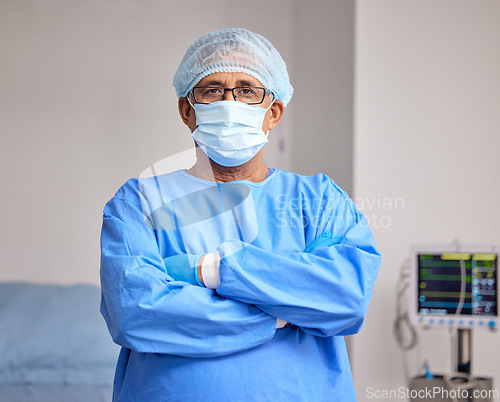 Image of Surgeon, portrait and man with arms crossed in hospital with confidence in emergency healthcare, medicine or cardiology. Doctor, face mask and pride in surgery, work and operating room or theater