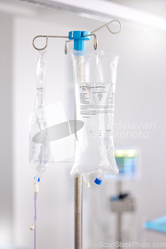 Image of Hospital, healthcare and an iv drip for medicine in a ward for medical support, health or emergency. Surgery, room and equipment or a liquid or fluid bag in icu at a clinic for medication help