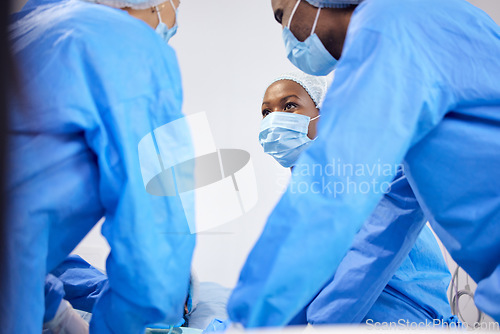Image of Doctors, hospital and surgeon team in theatre and emergency, healthcare or medical procedure. Group or staff with collaboration, healing or surgery and operation with support and scrubs in ICU