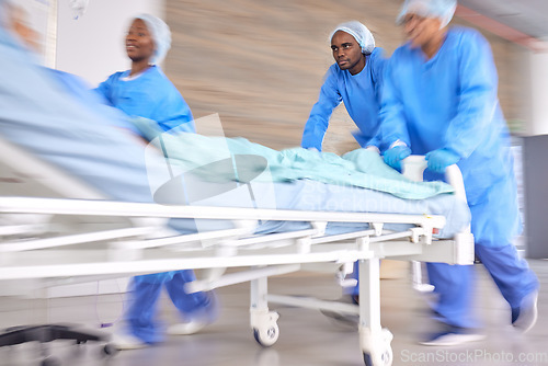 Image of Surgery, emergency and running with doctors in hospital for medical, accident and operating room. Medicine, healthcare and wellness with people and rush in clinic for teamwork, fast and motion blur