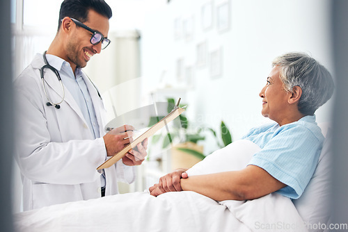 Image of Happy woman in bed, doctor with medical chart and checklist for health insurance, consultation and advice. Smile in hospital, healthcare professional with patient information, results and talking.