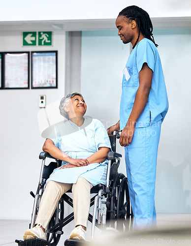 Image of Healthcare, wheelchair and senior patient with her nurse in an assisted living home for care or service. Medical, smile and a black man caregiver working to help an elderly woman with a disability