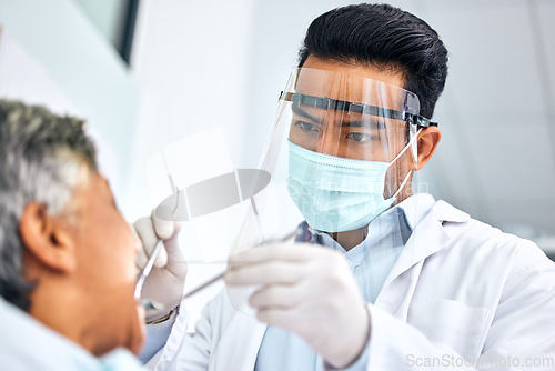 Image of Covid, dental or healthcare with a dentist and patient in an office for oral surgery or operation. Medical, teeth and oral hygiene with a medicine professional in a clinic to examine mouth and gums