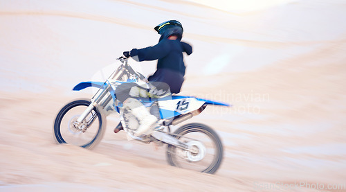 Image of Dirt, motorbike and athlete with speed in sports, adventure and driving on desert, sand dune and outdoor riding in nature. Extreme sport, bike or motorcycle drive with helmet, gear or man in action