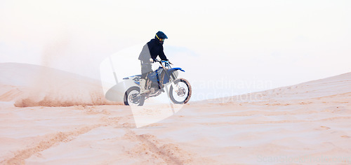 Image of Sand, dust or athlete driving motorcycle for action, adventure or fitness with performance or adrenaline. Desert, sports or person on motorbike on dunes for training, exercise or race or challenge