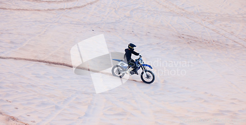 Image of Sand, travel or athlete driving motorcycle for action, adventure or fitness with performance or adrenaline. Desert, sports or person on motorbike on dunes for training, exercise or race or challenge