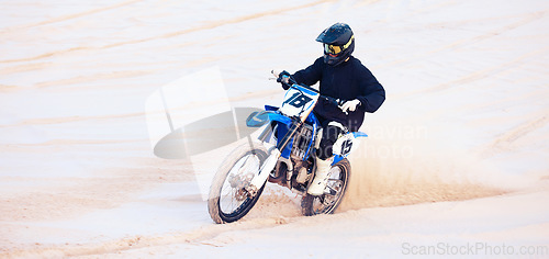 Image of Desert, speed or athlete driving motorcycle for action, adventure or fitness with performance or adrenaline. Sand, fast or sports person on motorbike on dunes for training, exercise or race challenge