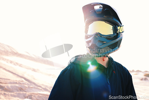 Image of Helmet, flare and an off road biker outdoor for a race, competition or adrenaline in summer. Freedom, energy and adventure with a sports rider on a course for power or speed in a reflective visor