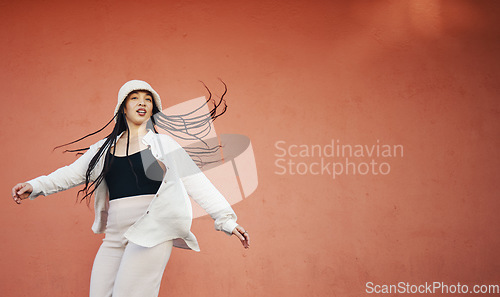 Image of Fashion, space and an urban woman on a red background for freedom, energy or unique street style. Wall, mock up and hip hop with a young gen z person on a color backdrop for marketing or advertising