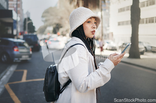 Image of Woman on street with phone, taxi app and travel holiday with streetwear, waiting and online location. Influencer, blogger or gen z girl with urban fashion, smartphone and cab transport in city road