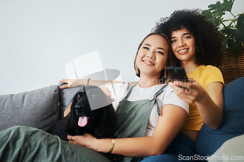 Image of Dog, relax or gay couple watching tv in home together in a lgbtq love connection on living room sofa. Remote, sofa or happy lesbian women smile with pet, bond or care on couch for movie on television