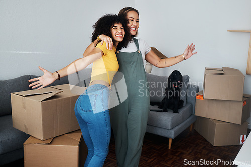 Image of Lesbian, couple and hug for moving, home and dog in living room with excited, happiness and celebration in apartment or property. Happy, people and women together with boxes and pet in new house
