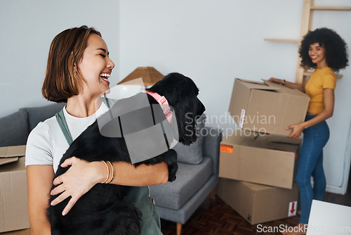 Image of Dog, lesbian couple and new real estate, funny and bonding together in living room. Happy gay women with pet in house, apartment and moving in to property home, laughing and playing with animal