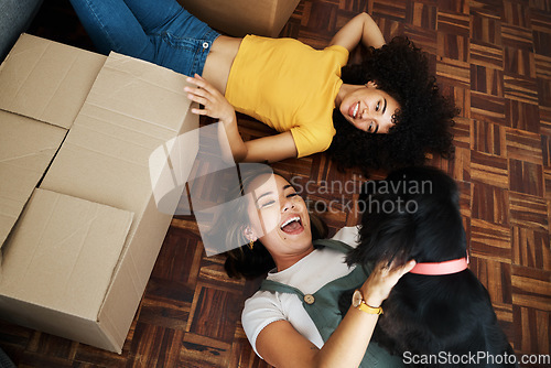 Image of Moving, boxes and couple with a dog in home, living room or women relax together on floor bonding with puppy or pet. New house, happiness or people with love for animal and investment in property