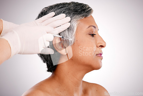 Image of Anti aging, gloves and senior woman with needle, beauty and skincare on a white studio background. Hands, mature person and model with plastic surgery, cosmetics or healthcare with wellness or filler