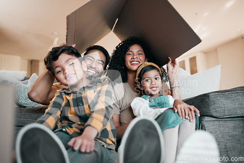 Image of New home, family and portrait with cardboard box for moving, mortgage and property purchase. Living room, smile and parents with kids and bonding together with love and children laughing with mom