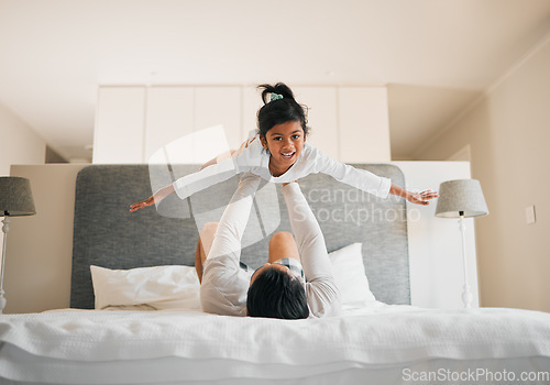 Image of Portrait, child and dad on bed for airplane games, support and relax for crazy fun together at home. Father, girl kid and excited to fly for freedom, fantasy and balance for play, trust and energy