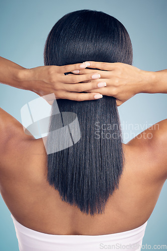 Image of Beauty, hair and hands with a woman from the back in studio on a gray background for shampoo treatment. Keratin, spa or salon for haircare and a model closeup with natural and aesthetic growth