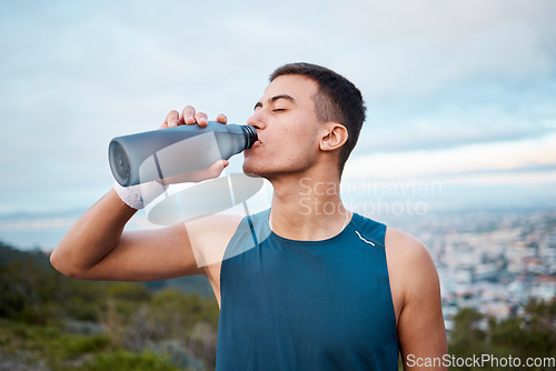 Image of Man, fitness and drinking water in nature, workout or outdoor exercise on break, rest or recovery. Thirsty male person, sports drink or mineral for sustainability after running, cardio or training