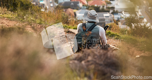 Image of Back, relax and view with a man hiking on mountain terrain for travel, freedom or adventure in a remote location. Hike, rest and scenic with a backpacker or hiker outdoor in nature to explore